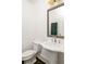Powder room with a pedestal sink and decorative mirror at 9071 Selborne Ln, Chattahoochee Hills, GA 30268