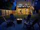 Evening in the backyard, showcasing a lit fire pit and string lights on the deck at 1542 Idlewood Rd, Tucker, GA 30084