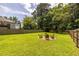 Large backyard with a fire pit and ample green space, great for outdoor activities at 1542 Idlewood Rd, Tucker, GA 30084