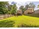 Wide backyard showing fire pit, deck and fenced perimeter, offering lots of space at 1542 Idlewood Rd, Tucker, GA 30084