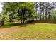 Expansive backyard with mature trees and lawn, offering privacy and space at 1542 Idlewood Rd, Tucker, GA 30084