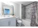 Bathroom with a white vanity, framed mirror, tub and shower with marble-style tile surround at 1542 Idlewood Rd, Tucker, GA 30084
