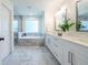 Elegant bathroom featuring double vanity sinks, a soaking tub, and a separate glass-enclosed shower at 1542 Idlewood Rd, Tucker, GA 30084