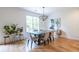 Bright dining room features hardwood floors, a modern chandelier, and a large window overlooking the backyard at 1542 Idlewood Rd, Tucker, GA 30084