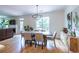 Open concept dining room shows the fireplace, hardwood floors, and access to the deck and an open living space at 1542 Idlewood Rd, Tucker, GA 30084