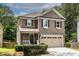 Charming two-story home with a covered porch, two car garage, and well-manicured landscaping at 1542 Idlewood Rd, Tucker, GA 30084