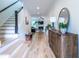 Hallway with hardwood floors, staircase, modern console and convenient access to the living area at 1542 Idlewood Rd, Tucker, GA 30084