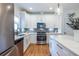 Gourmet kitchen with white cabinets, stainless steel appliances, gas cooktop, tile backsplash, and a view of the backyard at 1542 Idlewood Rd, Tucker, GA 30084
