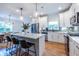 The newly renovated kitchen features a stylish island with seating, stainless steel appliances, and modern pendant lights at 1542 Idlewood Rd, Tucker, GA 30084