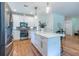 The kitchen has bright white cabinets, an island, hardwood floors and stainless steel appliances at 1542 Idlewood Rd, Tucker, GA 30084