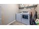 Laundry room featuring a washer, dryer, storage shelves, and neutral-toned walls at 1542 Idlewood Rd, Tucker, GA 30084