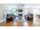 Bright living room with hardwood floors, a ceiling fan, and a cozy fireplace at 1542 Idlewood Rd, Tucker, GA 30084