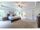 Spacious main bedroom with a tray ceiling, ceiling fan, and lots of natural light at 1542 Idlewood Rd, Tucker, GA 30084
