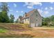 Rear view of a two-story home featuring an attached garage and spacious backyard at 167 Gothards Creek Dr, Powder Springs, GA 30127