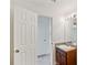 Bright bathroom with single sink vanity, mirror and access to an additional room at 167 Gothards Creek Dr, Powder Springs, GA 30127
