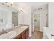 Bright bathroom showcasing double sinks, a large mirror, and a walk-in closet at 167 Gothards Creek Dr, Powder Springs, GA 30127