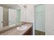 This bathroom includes a vanity with storage, mirror, and view into the shower at 167 Gothards Creek Dr, Powder Springs, GA 30127