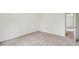 Bedroom featuring neutral carpet, white walls, and access to another room at 167 Gothards Creek Dr, Powder Springs, GA 30127