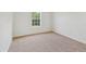 Bright bedroom with neutral carpet, white walls, and a window providing natural light at 167 Gothards Creek Dr, Powder Springs, GA 30127