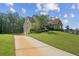 Two-story home with a long driveway, well-manicured lawn, and a combination of stone and siding at 167 Gothards Creek Dr, Powder Springs, GA 30127