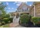 Charming two-story home featuring a covered front porch, landscaped yard, and stone and siding exterior at 167 Gothards Creek Dr, Powder Springs, GA 30127