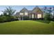 Charming home with a covered front porch, stone and siding exterior, and a well-manicured lawn at 167 Gothards Creek Dr, Powder Springs, GA 30127