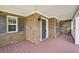 Covered front porch with brick exterior and pink wood flooring at 167 Gothards Creek Dr, Powder Springs, GA 30127