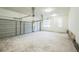 Spacious two car garage featuring concrete floors, overhead lighting, and window at 167 Gothards Creek Dr, Powder Springs, GA 30127