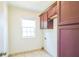 Practical laundry room features tile flooring, window, cabinets and room for a washer/dryer at 167 Gothards Creek Dr, Powder Springs, GA 30127