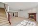 Spacious living room with a brick fireplace and staircase leading to the second floor at 167 Gothards Creek Dr, Powder Springs, GA 30127