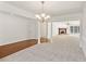 Open floorplan living room with carpeted and hardwood floors and white walls at 167 Gothards Creek Dr, Powder Springs, GA 30127