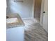 Well-lit bathroom showcasing a granite countertop, white cabinets, and modern marble floors at 3006 Dogwood Dr, Hapeville, GA 30354