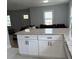 Open-concept kitchen featuring a granite-topped island, white cabinetry, and seamless flow to the living area at 3006 Dogwood Dr, Hapeville, GA 30354