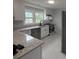 Stylish kitchen with granite countertops, white cabinetry, stainless steel appliances, and breakfast bar at 3006 Dogwood Dr, Hapeville, GA 30354