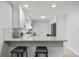 Stylish kitchen with granite countertops, white cabinetry, stainless steel appliances, and breakfast bar at 3006 Dogwood Dr, Hapeville, GA 30354