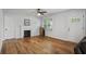 Bright living room features hardwood floors, a fireplace, and a window for natural light at 3006 Dogwood Dr, Hapeville, GA 30354
