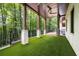 Large covered patio area with ceiling fans and a spacious backyard surrounded by lush greenery at 306 Pinecrest Ne Rd, Atlanta, GA 30342