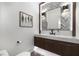 Elegant powder room with chevron-patterned wall, marble countertop, and dark wood vanity at 306 Pinecrest Ne Rd, Atlanta, GA 30342