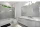 A full bathroom with bright tile, a glass shower, and modern finishes at 306 Pinecrest Ne Rd, Atlanta, GA 30342