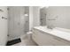 Modern bathroom featuring a sleek vanity, an oversized mirror, and a glass-enclosed shower at 306 Pinecrest Ne Rd, Atlanta, GA 30342