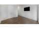 A bedroom with light wood floors and a television mounted on the wall at 306 Pinecrest Ne Rd, Atlanta, GA 30342