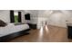 Modern bedroom with large window, mounted TV, and sleek furniture against the backdrop of hardwood floors at 306 Pinecrest Ne Rd, Atlanta, GA 30342