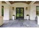 Home entrance featuring black framed glass doors, stone floors, and lantern style lighting at 306 Pinecrest Ne Rd, Atlanta, GA 30342
