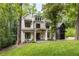 Stunning home exterior featuring manicured landscaping, lush trees, and a welcoming front porch at 306 Pinecrest Ne Rd, Atlanta, GA 30342