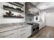 Contemporary kitchen showcasing marble countertops, under cabinet lighting, and stainless-steel appliances at 306 Pinecrest Ne Rd, Atlanta, GA 30342