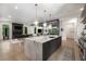 Open-concept kitchen and dining area with an island and bar that leads to a connected living room at 306 Pinecrest Ne Rd, Atlanta, GA 30342