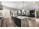 Modern kitchen with island seating that overlooks the dining area, wet bar and fireplace at 306 Pinecrest Ne Rd, Atlanta, GA 30342