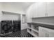 Modern laundry room with sleek washer/dryer, unique floors, and wash station at 306 Pinecrest Ne Rd, Atlanta, GA 30342