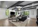Stunning living room with coffered ceilings, a modern chandelier, and large glass doors to the backyard at 306 Pinecrest Ne Rd, Atlanta, GA 30342