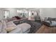 Spacious living area boasts a large sectional, gray carpet, and a view to the game area at 306 Pinecrest Ne Rd, Atlanta, GA 30342